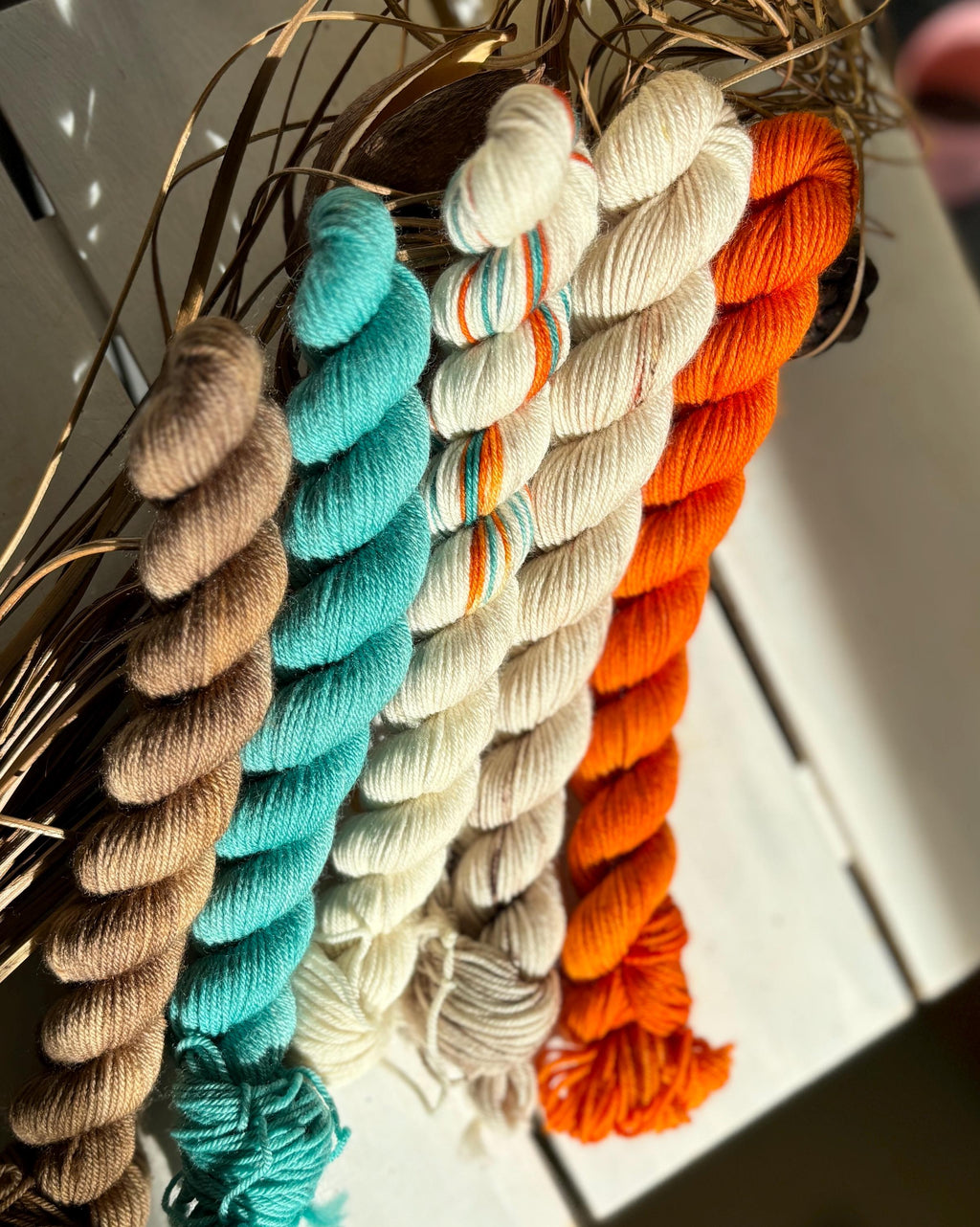 Feathers & Flowers, a merino, hand dyed yarn soft natural beige, saffron orange, teal green
