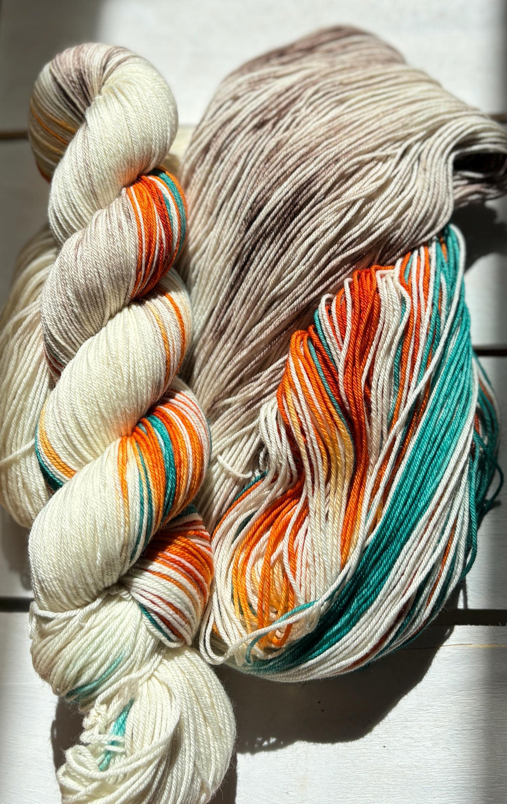 Feathers & Flowers, a merino, hand dyed yarn soft natural beige, saffron orange, teal green
