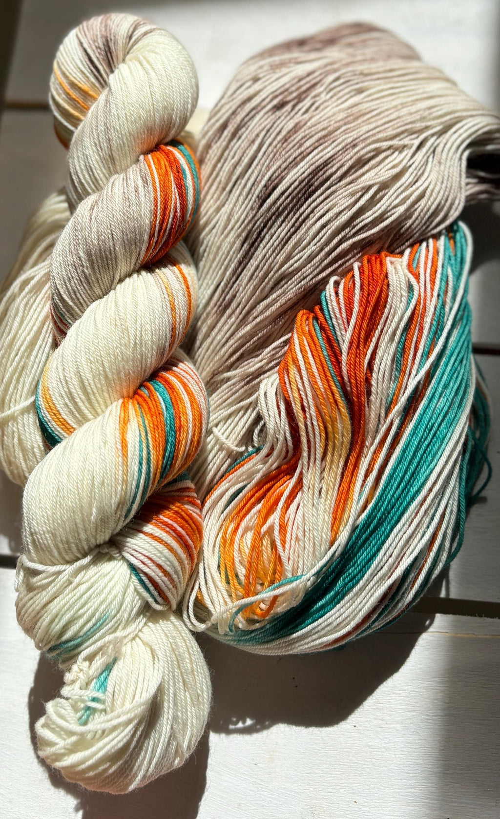Feathers & Flowers, a merino, hand dyed yarn soft natural beige, saffron orange, teal green