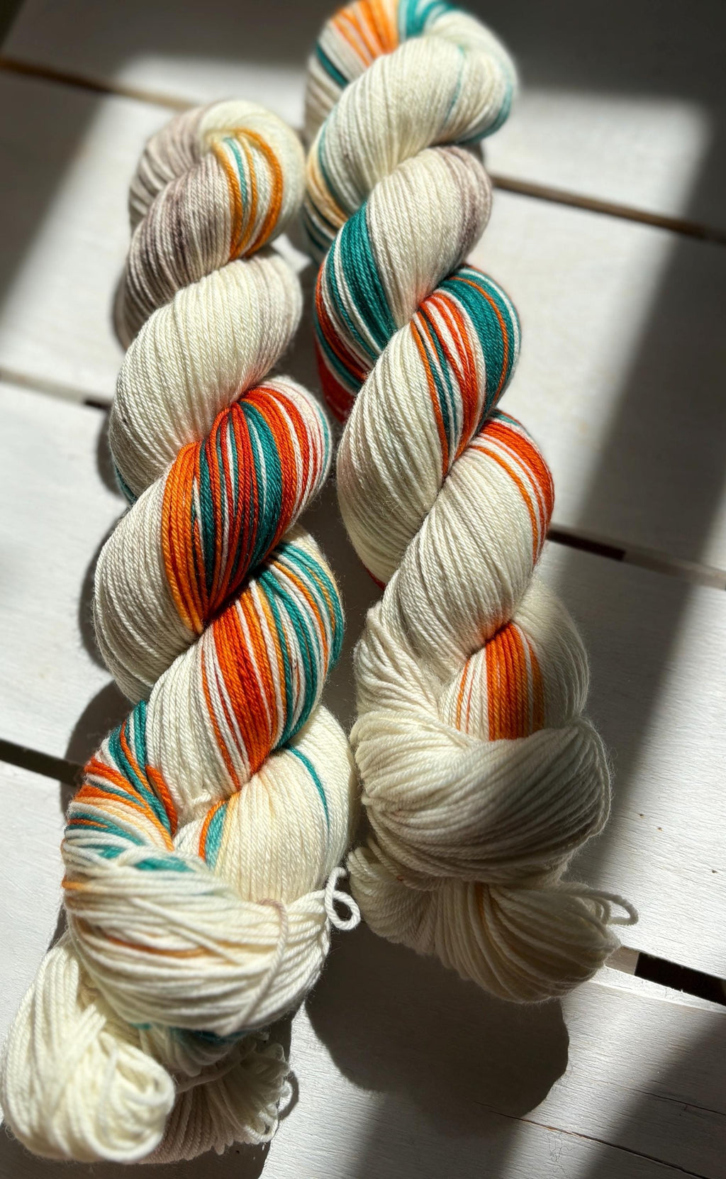 Feathers & Flowers, a merino, hand dyed yarn soft natural beige, saffron orange, teal green