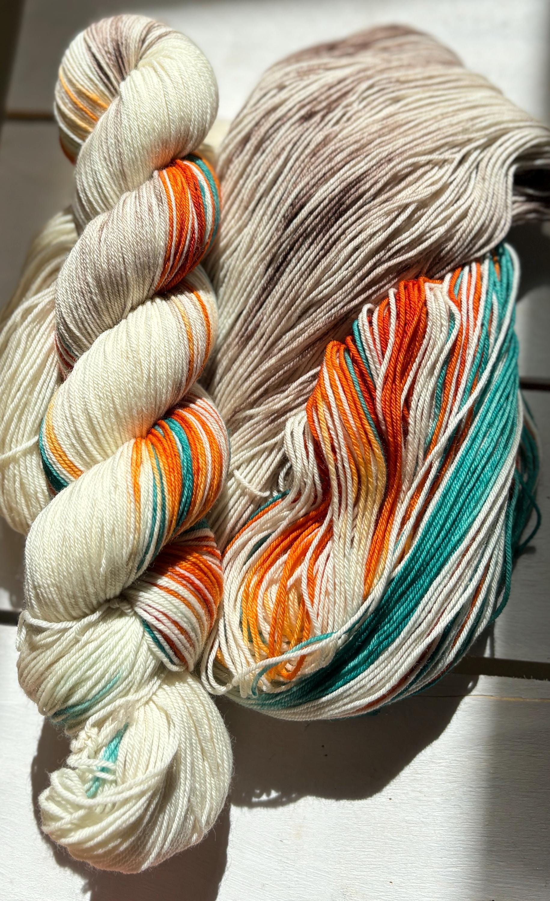 Feathers & Flowers, a merino, hand dyed yarn soft natural beige, saffron orange, teal green