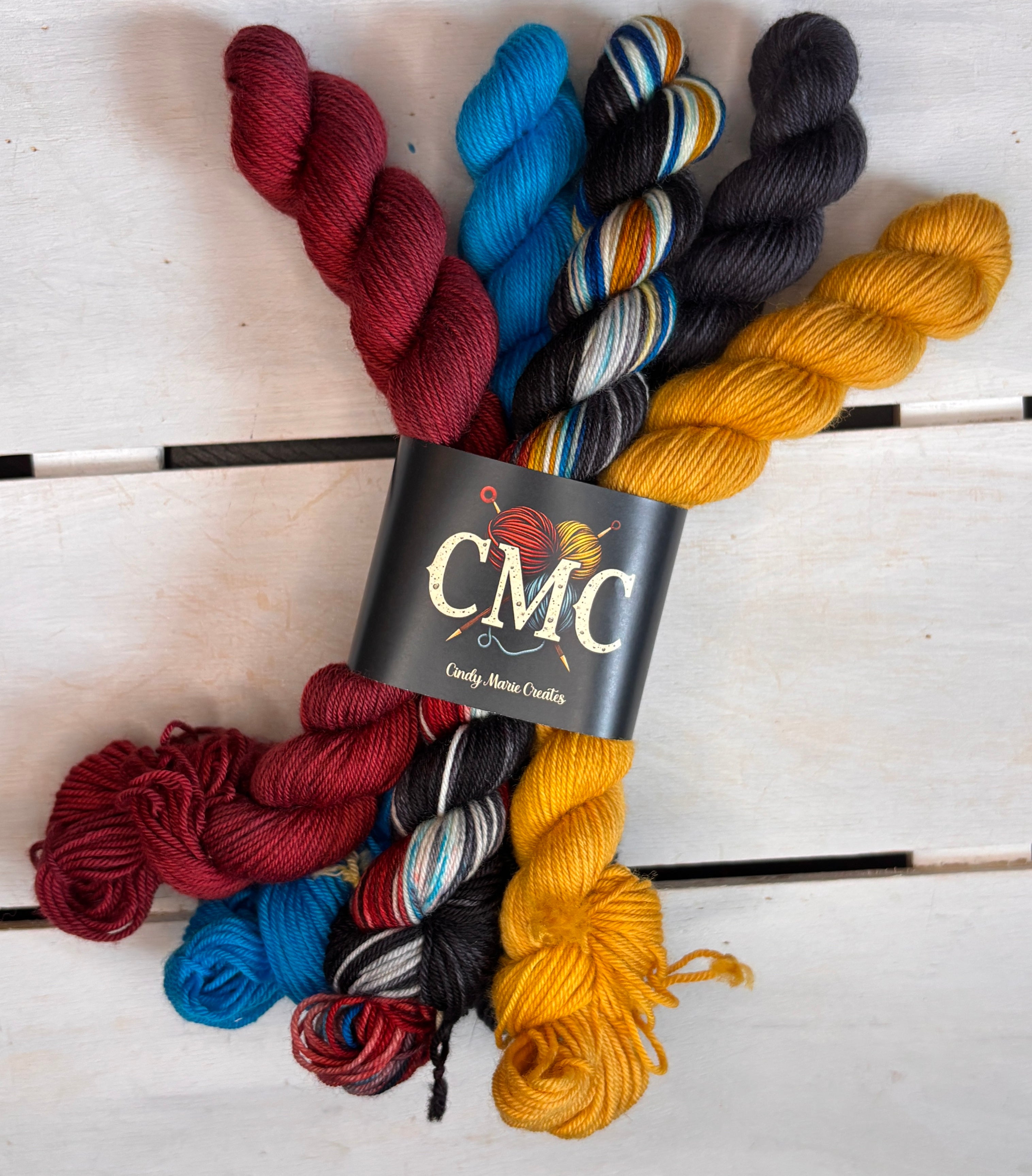 CMC logo, black red yellow blue varigated merino wool, DK Fingering